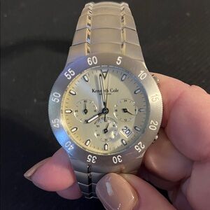 Kenneth Cole Men’s stainless steel running Chronograph silvertone dial watch.